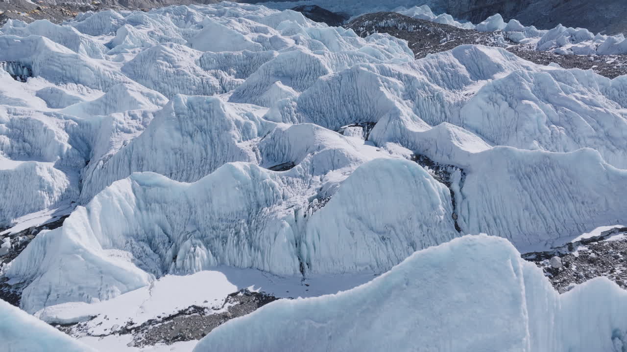 Aerial view of Everest Base Camp with white Khumbu glaciers, snow peaks, clear blue sky with sunny weather landscape dry and humid land