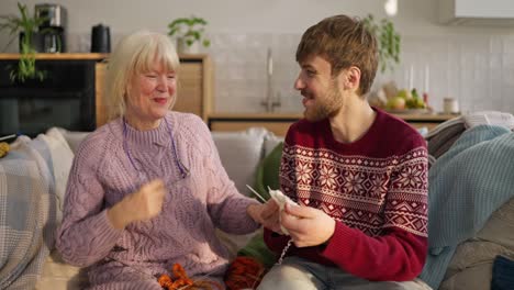 grandmother and grandson knitting together