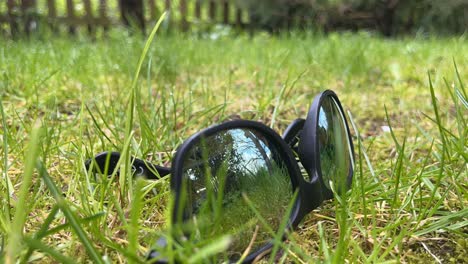 timelapse of sunglasses lying in the grass