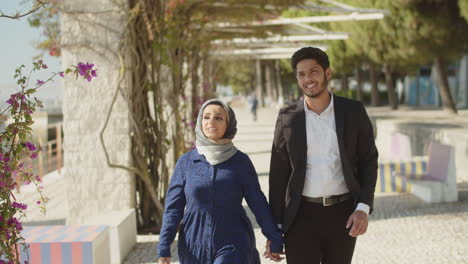 Medium-shot-of-Arabic-couple,-walking-along-alley