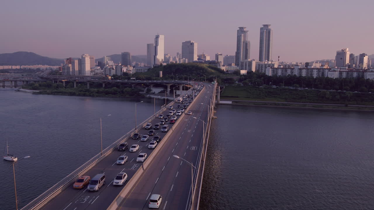 Aerial View of Traffic on a Bridge over a River in Seoul, South Korea at Sunset