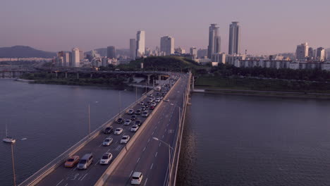 aerial view of traffic on a bridge over a river in seoul, south korea at sunset