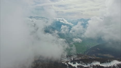 mountain landscape with valley view from above clouds, aerial drone flying