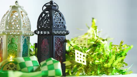 arabic lantern and ribbon ketupat on green background