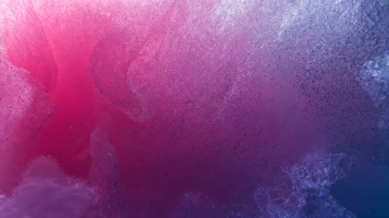 Shifting magenta-indigo light revealing crystal shards in enclosed cavity, showing surface glints