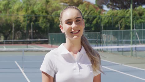 Video-Einer-Glücklichen-Kaukasischen-Tennisspielerin,-Die-In-Die-Kamera-Blickt