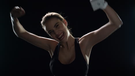 happy woman raising up hands with champion trophy in slow motion