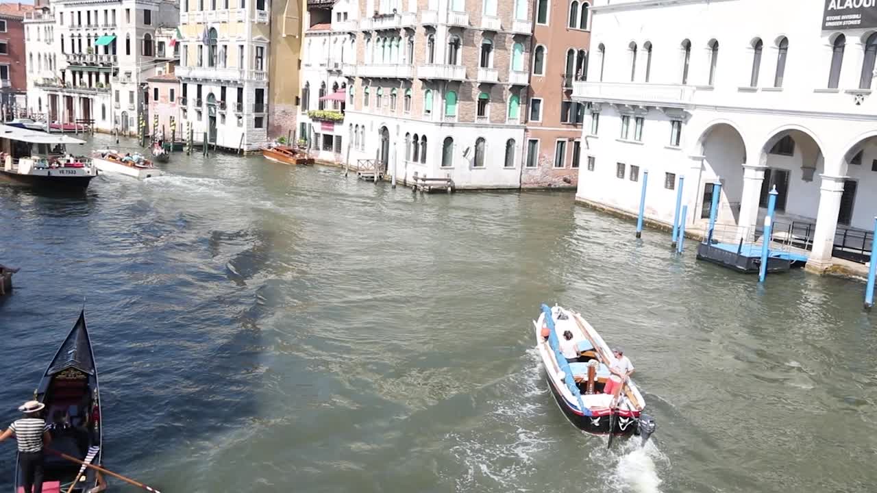 Charming Venice canal with bridge and colorful old buildings.