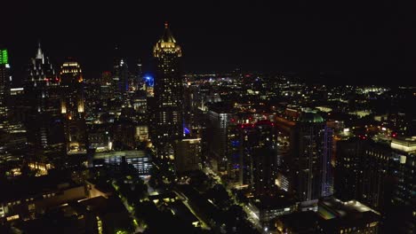 night shot flying away from lights and skyscrapers of downtown atlanta, georgia