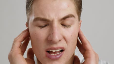 man experiencing ear or head pain