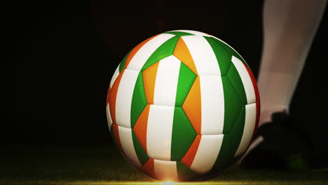 football player kicking ivory coast flag ball