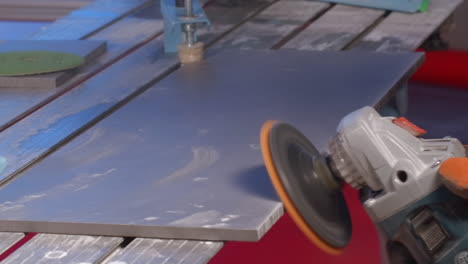 polishing a metal plate with a grinder