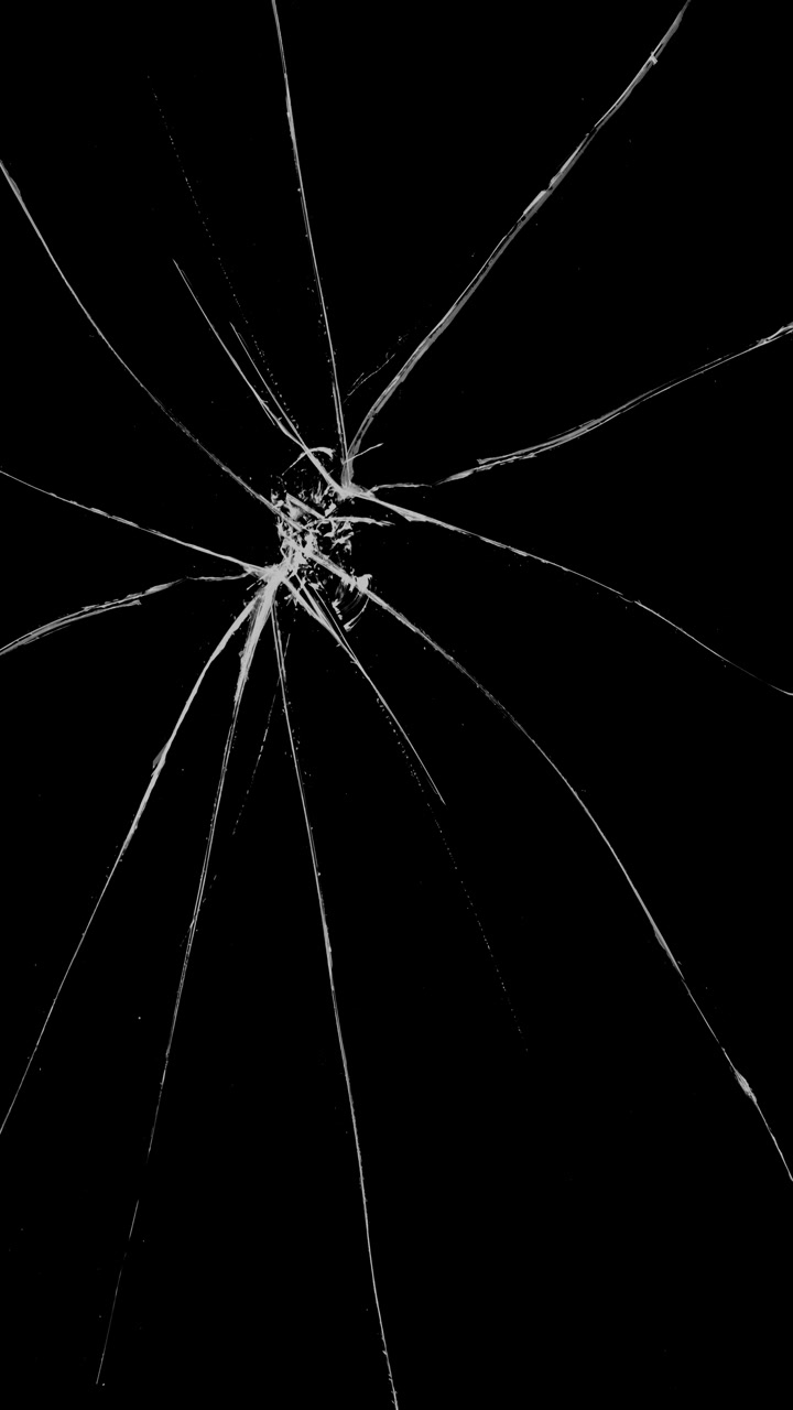 Vertical format spiderweb shattered glass or cracked screen effect on black background