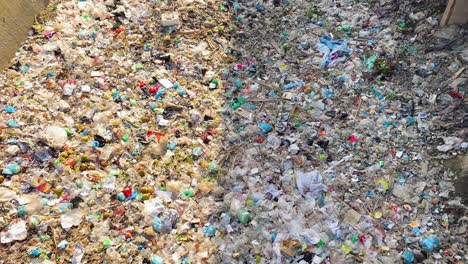 a dry canal clogged with landfill and pollution in the city of dhaka, bangladesh