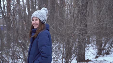 woman laughing in a snowy forest