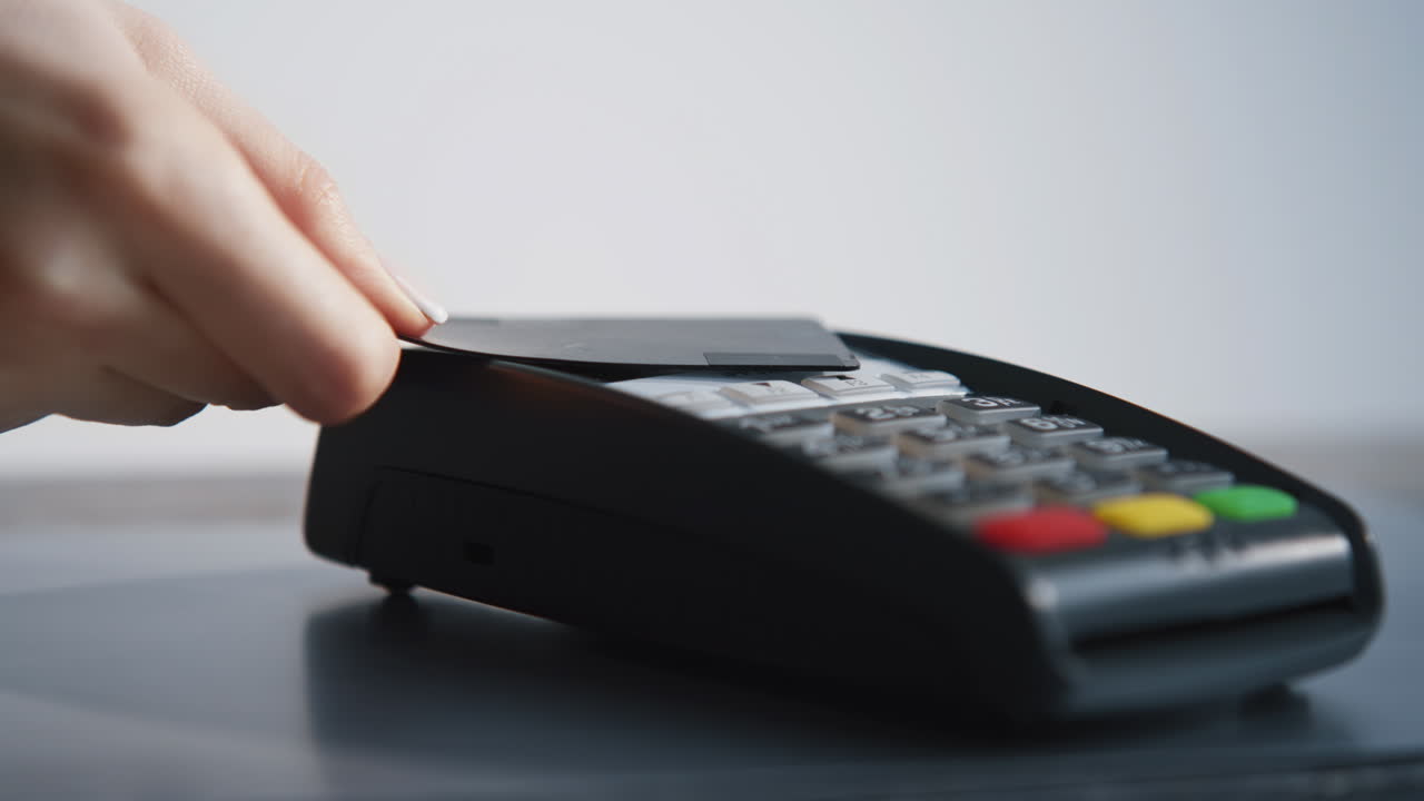 Closeup hands pay card contactless in shop. Unknown customer spending money