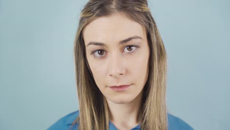 young woman looking dull at camera. unhappy, dissatisfied.