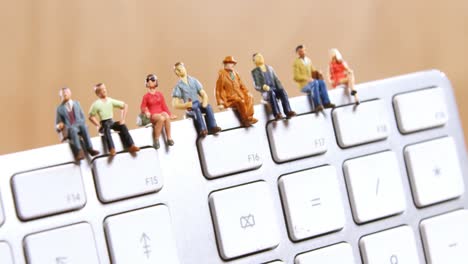 Figurine-sitting-on-a-keyboard