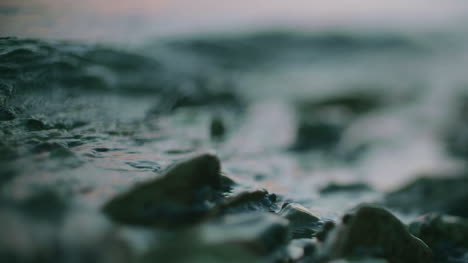 Blue-Water-Surface-Waving-Over-Stone