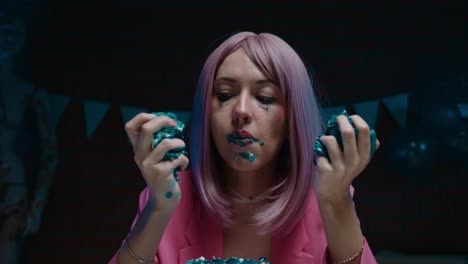 woman eating a teal cake