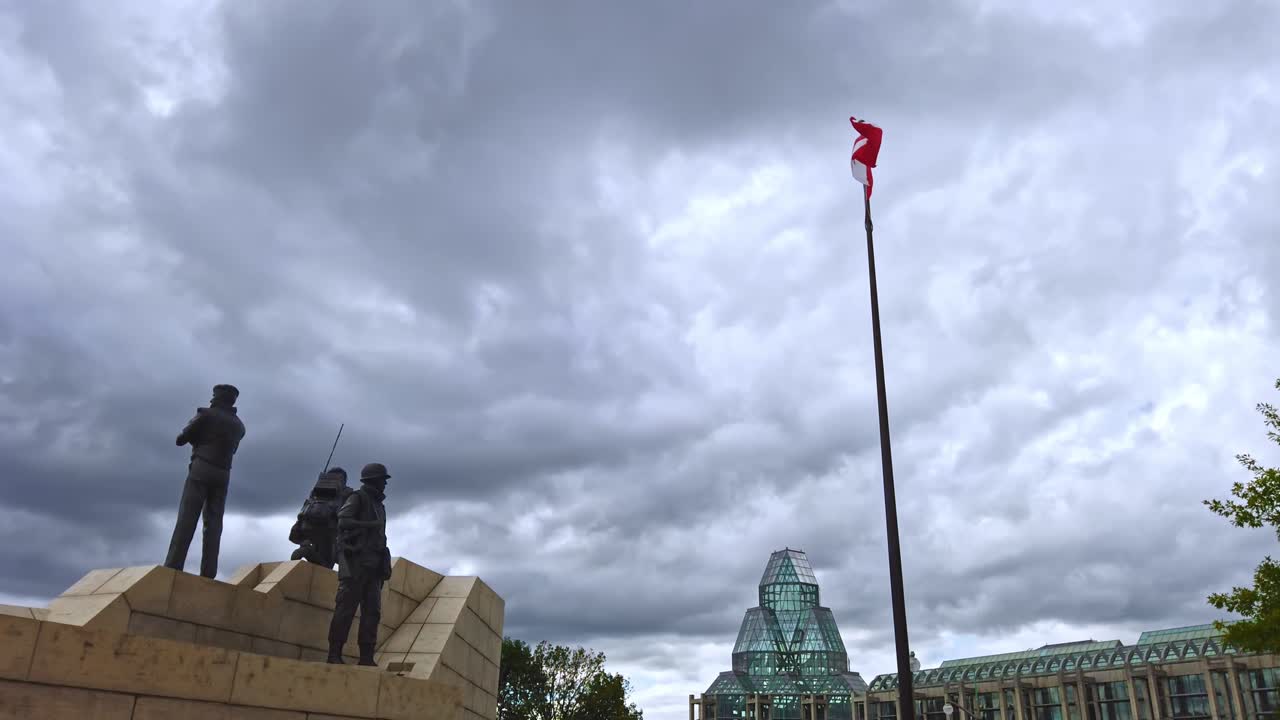 Reconciliation: The Peacekeeping Monument in Ottawa with Canadian flag blowing in the air