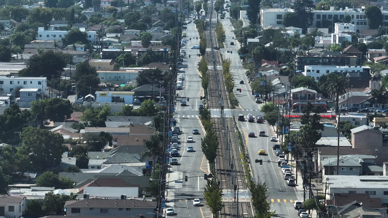 Telephoto drone shot of the streets and rail, sunny day in Los Angeles, USA