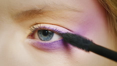 apply makeup on a beautiful female eye of blue color