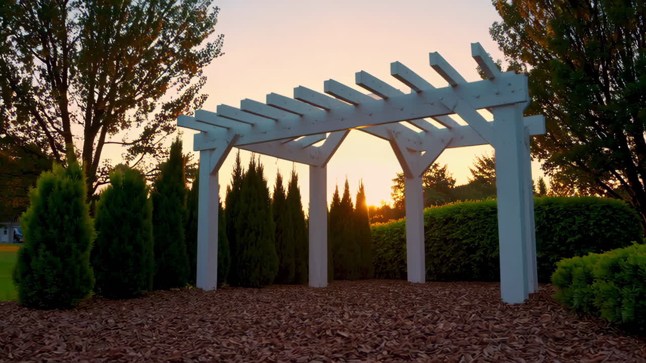 A White Wooden Pergola in a Serene Garden at Sunset