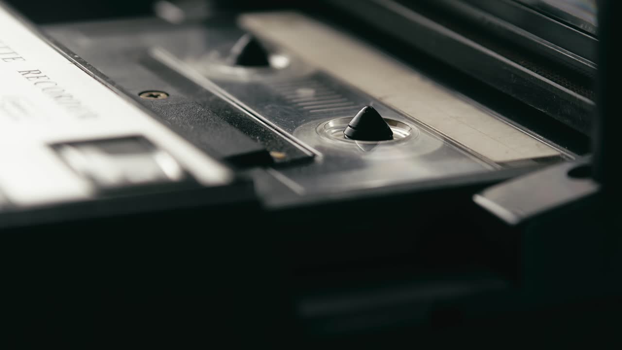 Retro cassette player tape playing back recording SIDE VIEW CLOSE-UP