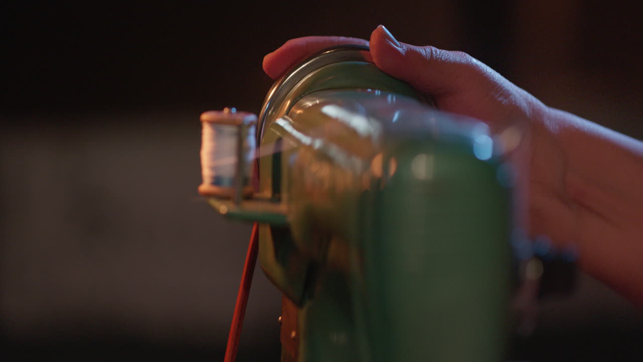 Close-Up of Hand Winding Thread onto Bobbin on Vintage Sewing Machine