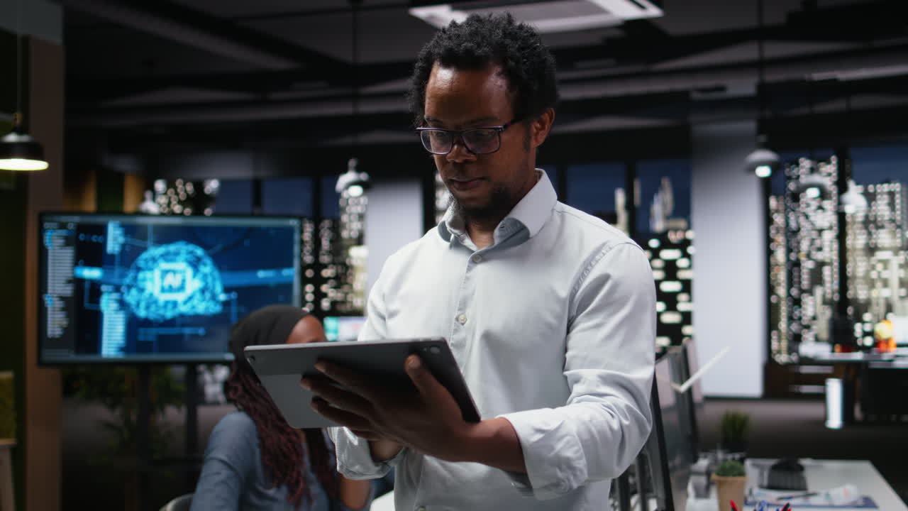 Smiling African American Businessman Using Tablet in Office