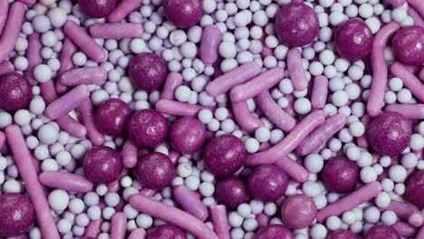 macro view of pink and white sprinkles rotating, showcasing texture and vibrant colors in a detailed close-up