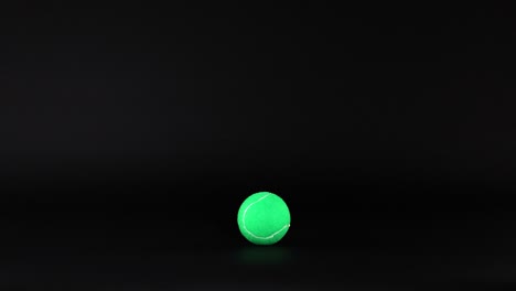 tennis balls moving across a dark background