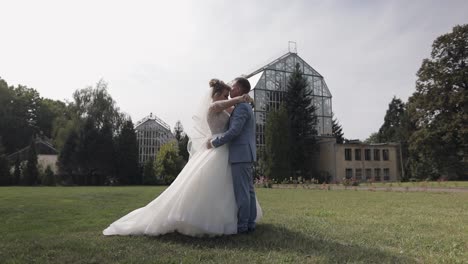 newlyweds. caucasian groom with bride in the park. wedding couple. happy family