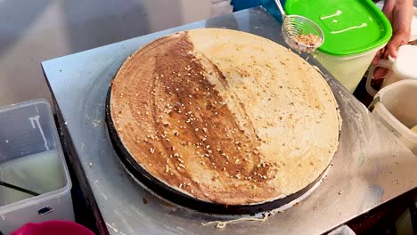 cooking sweet crepe on hot pan, close up view