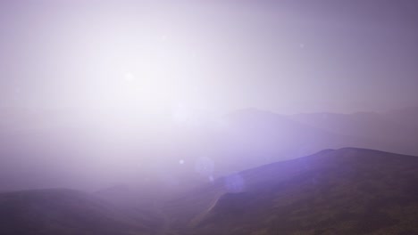 aerial green hills landscape in fog