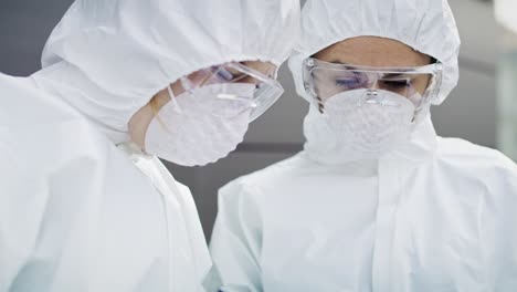 video of two technicians in protective suit