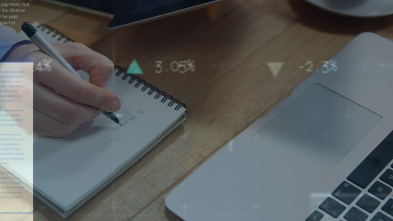 Animation of financial data and graphs over hands of caucasian man making notes