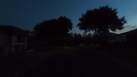 rear facing night driving point of view pov for interior car scene green screen replacement - a quiet and narrow suburban street