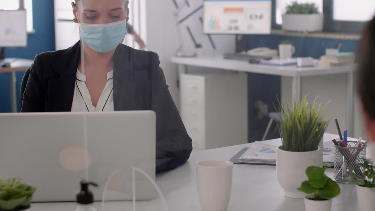 Close up of manager discussing with coworker looking at business statistics