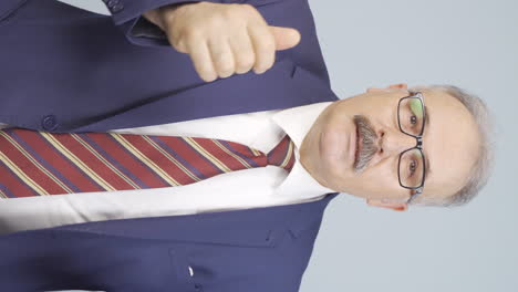 Vertical-video-of-Old-businessman-giving-motivational-speech-to-camera.