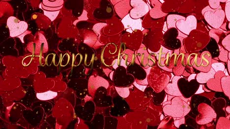 animation of happy christmas text over glowing pink hearts