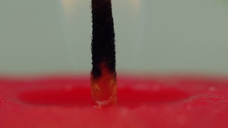 time lapse: macro studio view of hot melting wax falling down on hot wick