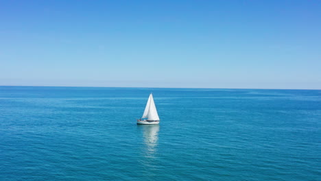 sailing-boat-on-the-mediterranean-sea-with-Valras-plage-in-background-aerial