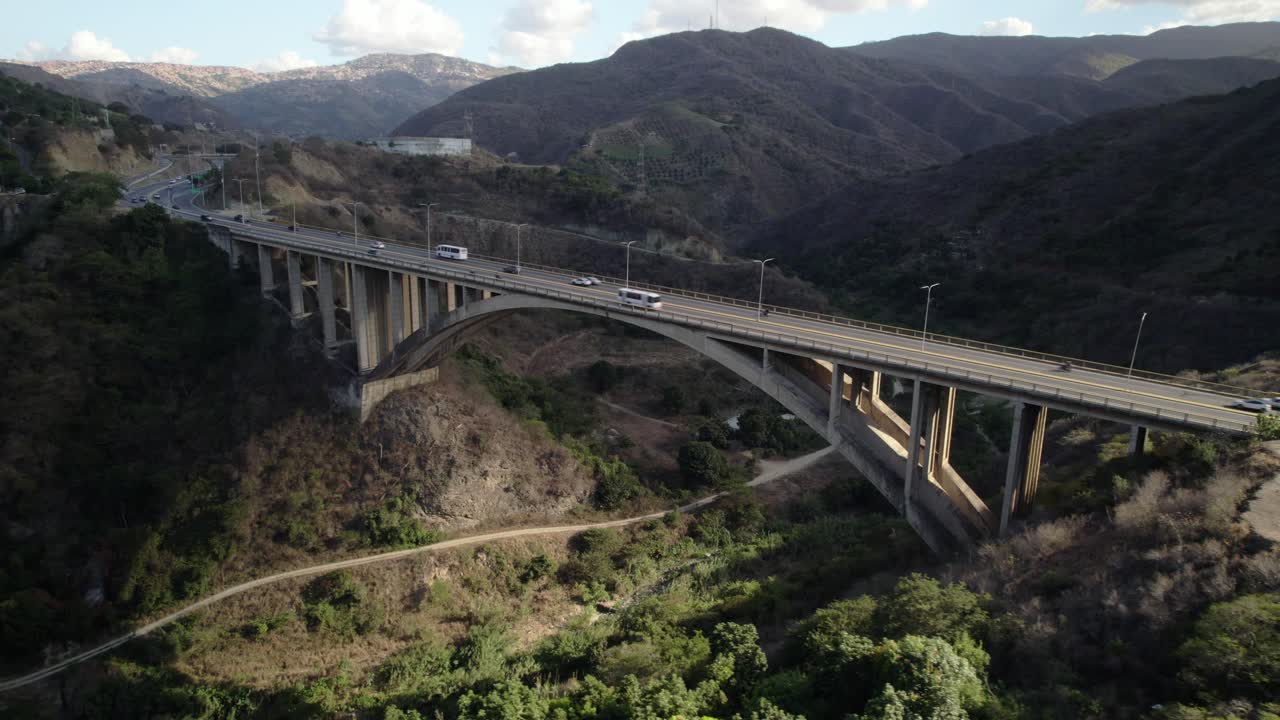 Mountain highway bridge with cars crossing Viaducto 2 near Caracas under clear skies