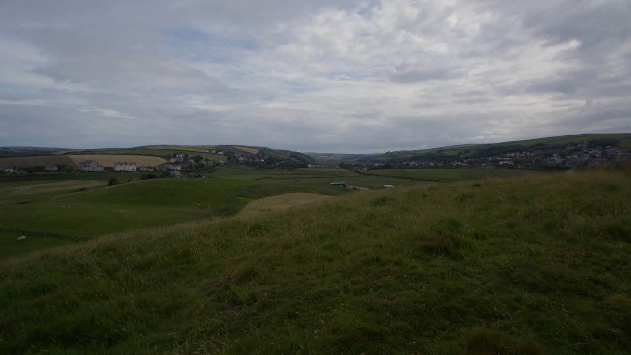 extra wide shot of the hills and village of St bees . West lake district