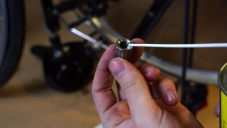 the-thread-of-a-screw-is-oiled-during-a-bicycle-repair