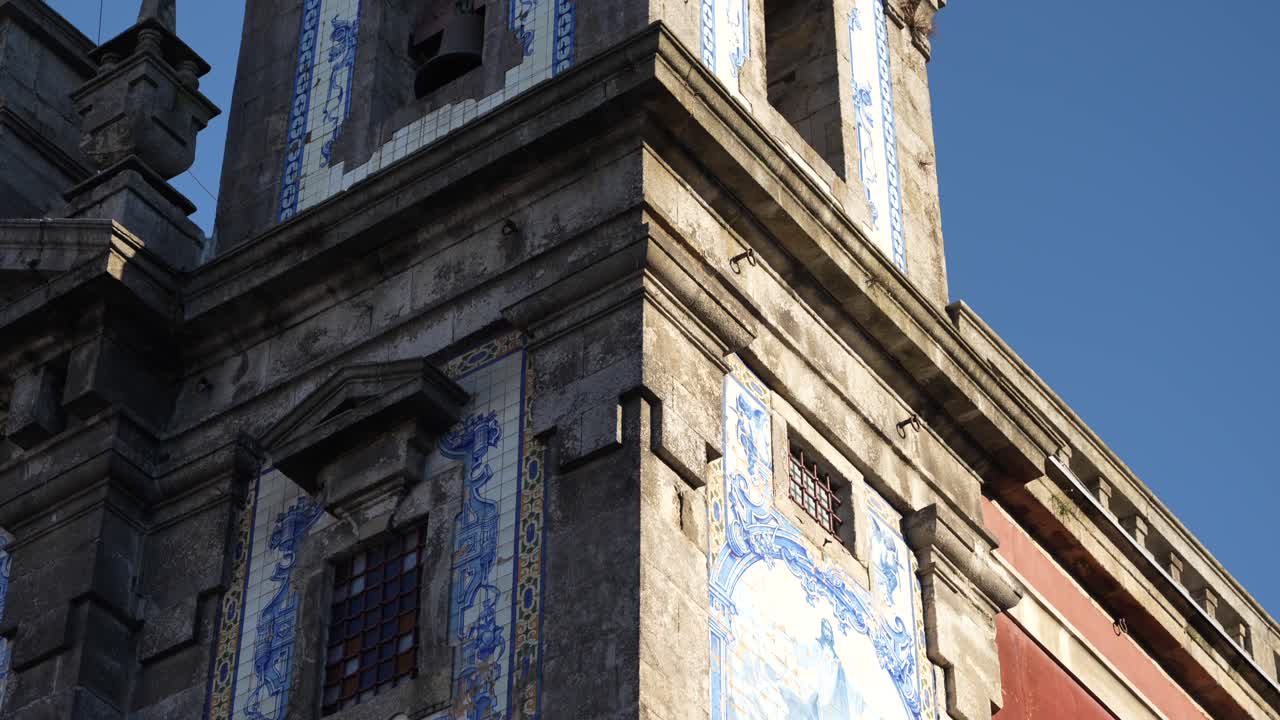 Ornate Portuguese azulejo artwork on historic Saint Ildefonso Church facade