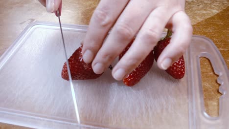 Knife-cuts-the-strawberries-Slow-motion-with-rotation-tracking-shot.