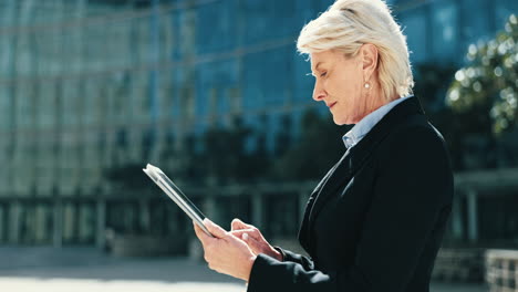 city, mature and a business woman with a tablet